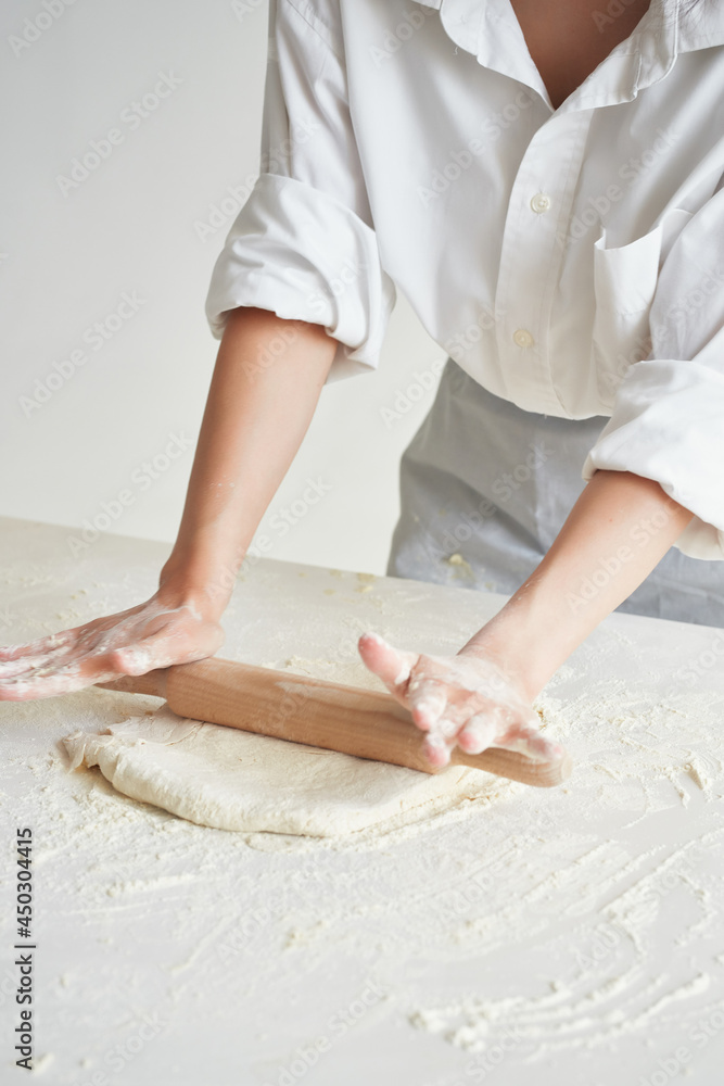 the chef rolls the dough cooking flour product in the kitchen