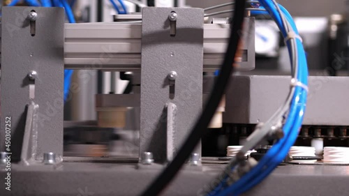 Honed automated operation of the blue machine on the conveyor production of plastic bottles.