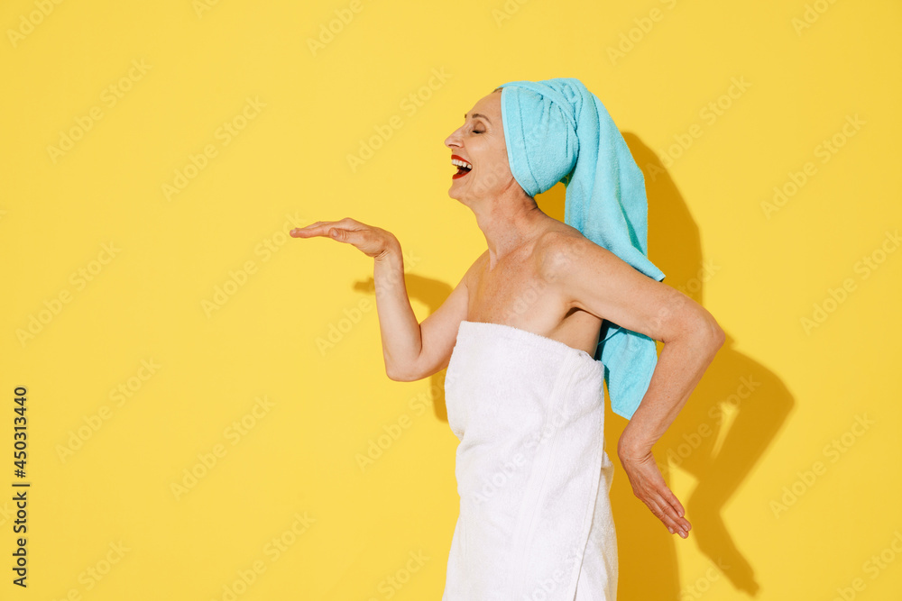 Senior woman wearing towels laughing while making fun Senior woman wearing towels laughing while making fun