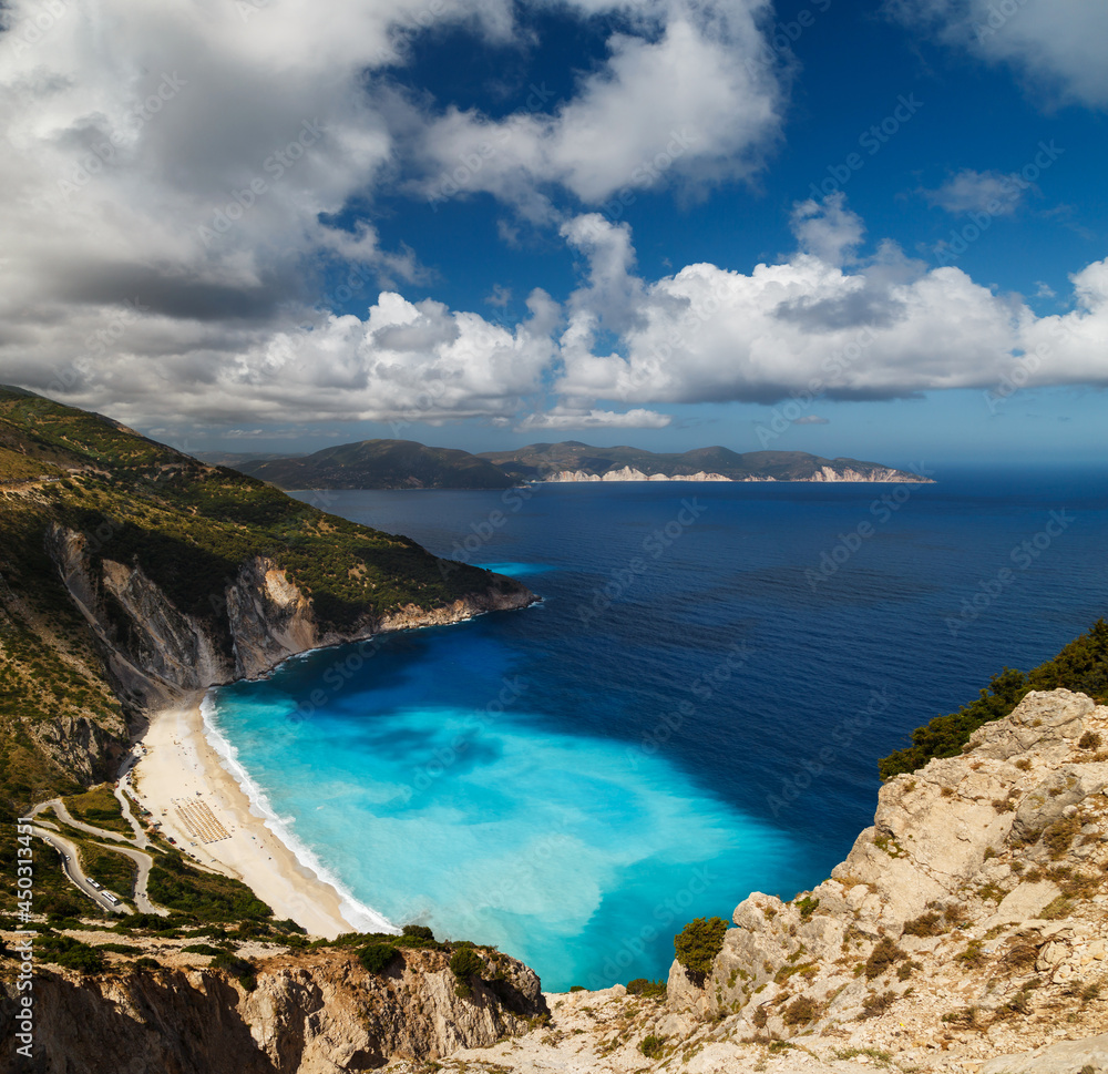 Fototapeta premium A top panoramic view at Myrtos Beach and fantastic turquoise and blue Ionian Sea water. Aerial view, summer scenery of famous and extremely popular travel destination in Cephalonia, Greece, Europe.