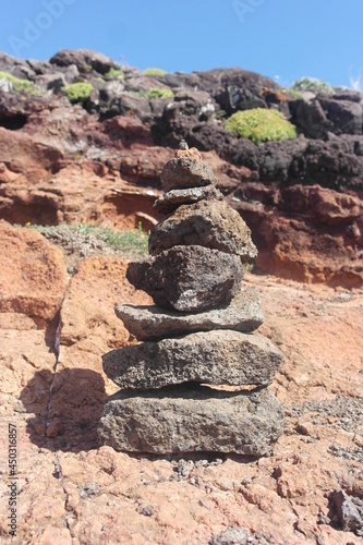 achievement hike experience: breathtaking route, landscape details: palette of soil layers, dry surface volcanic origin, stacked basalt stone, pile of stones. Madeira. Ponta de São Lourenço