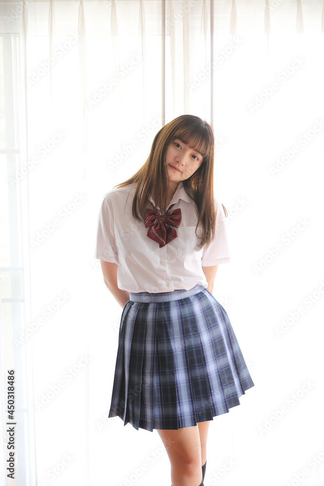 Portrait japanese school girl uniform in white tone bed room Portrait japanese school girl uniform in white tone bed room
