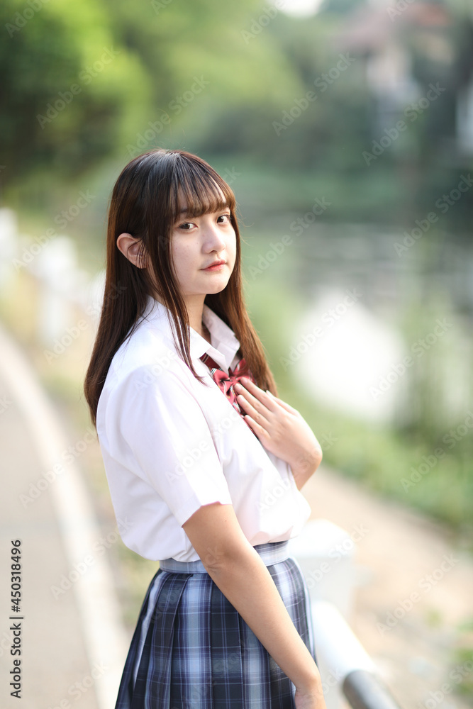 beautiful asian japanese school girl uniform looking at park outdoor