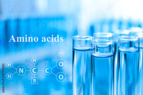 Amino Acids chemical formula, illustration. Test tubes with liquid samples for analysis in laboratory, closeup