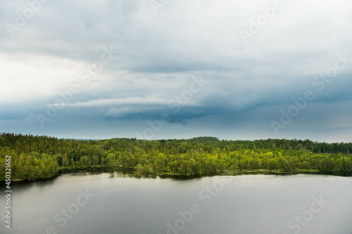 Fototapeta Naklejka Na Ścianę i Meble -  Storm with dark rain clouds over the Swedish forest and lakes at the Aboda Klint viewpoint in Högsby