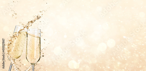 Fényképezés Glasses with sparkling wine and splashes on light background, space for text