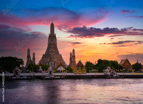 View of beautiful Wat Arun Rajvararam or Wat Arun or Wat Makok at waterfront of the Chao Phraya River in twilight,Which is historical significance and famous tourist destination of Bangkok,Thailand.