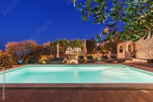 Illuminated pool on the summer terrace in the evening