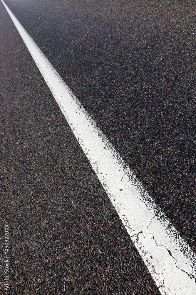 Fototapeta premium paved road with white road markings