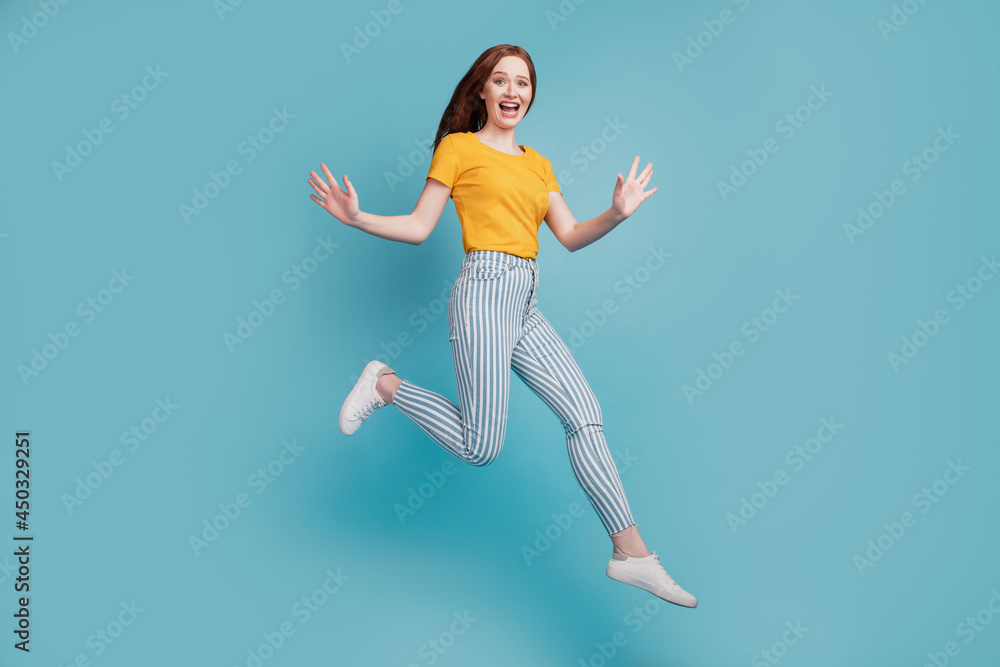 Portrait of carefree energetic lady jump run have fun on blue background Portrait of carefree energetic lady jump run have fun on blue background