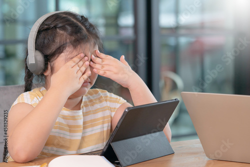 Asian girl covered her eyes from digital eye strain, girl used tablets too much to cause eye strain,eyes problems from using a tablet,education and vision problems.