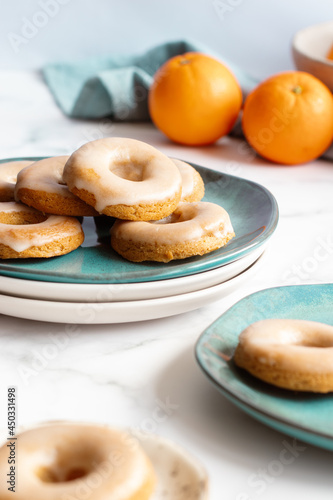 Home made baked whole wheat vegan donuts with orange glaze
