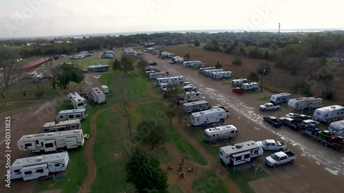 Aerial shot of of an RV Park with many vehicles 2. Drone video of the RV parking zone near the vehicle camping.