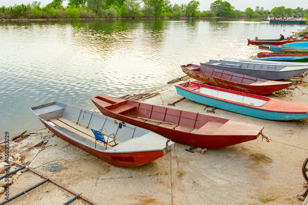 Metal fishing boats are dry docked above water Metal fishing boats are dry docked above water