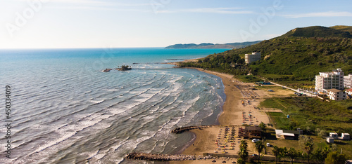View to sandy beach of Adriatic Sea and to the city of Durres, Albania during sunset. photo