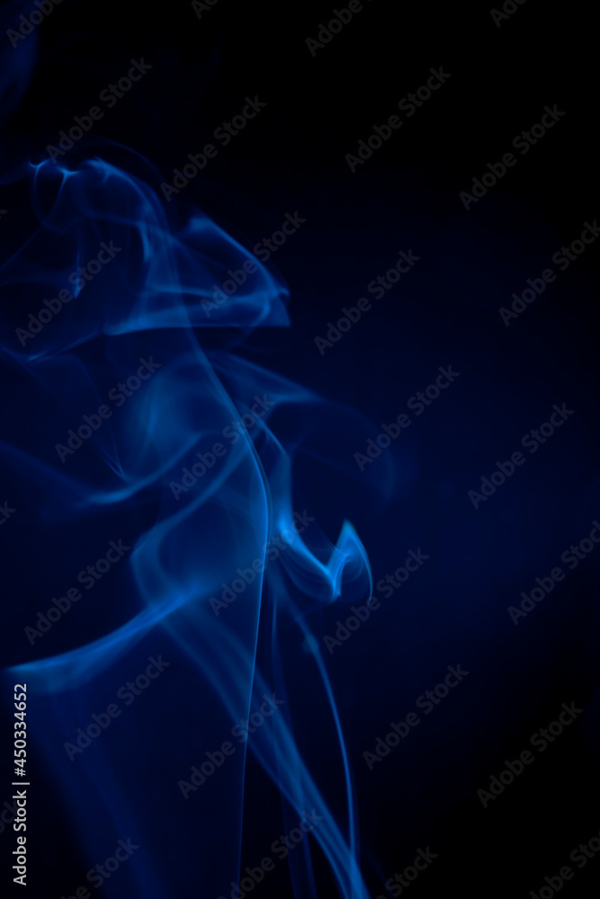 Obraz premium Blue smoke on black background.