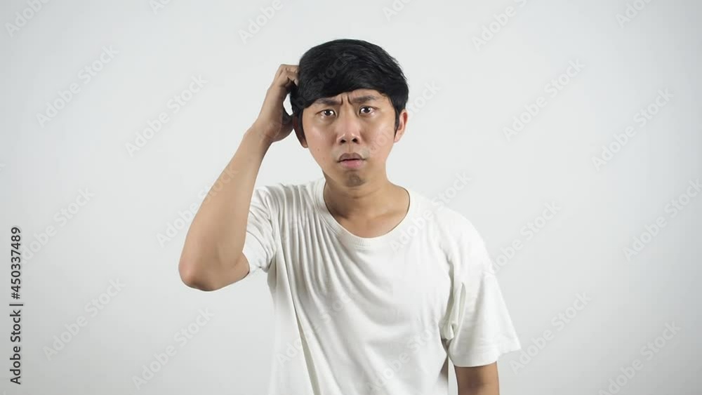 Man white shirt feeling confused and standing scratch his head look at camera Man white shirt feeling confused and standing scratch his head look at camera