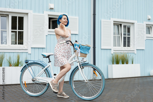 Cute lesbian on a white bike with busket.