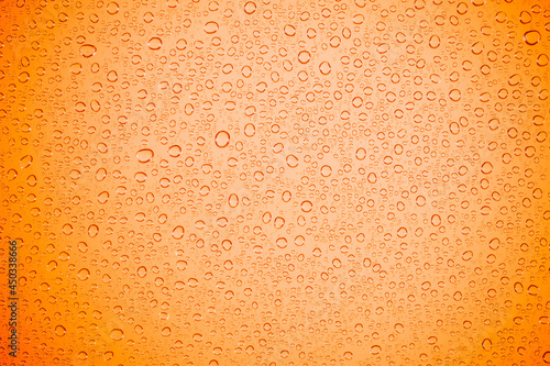 Water bubble on orange glass.