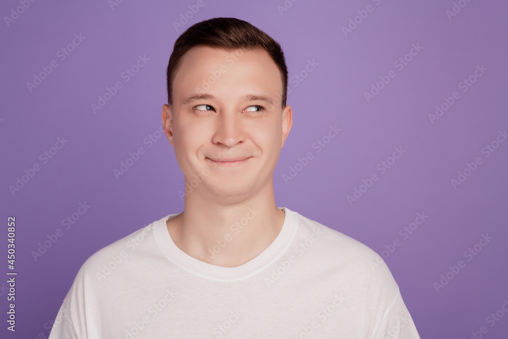 Portrait of curious thoughtful positive guy look empty space on purple background Portrait of curious thoughtful positive guy look empty space on purple background