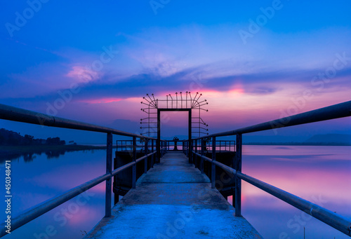 Bridges and gates on the lakes have colorful twilight skies. 