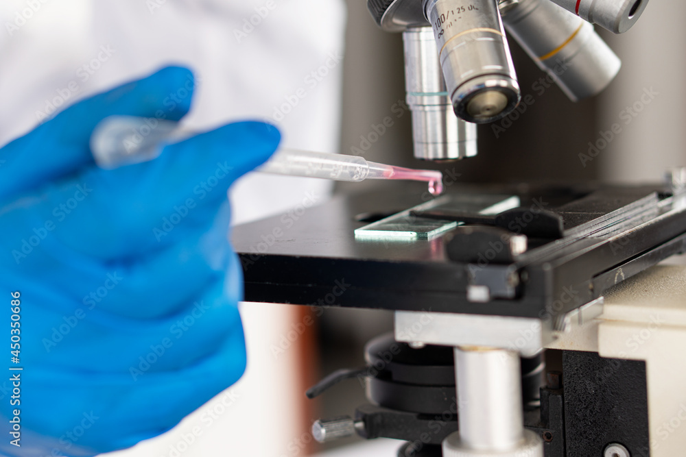 a professional scientist or researcher holding a test tube The pipette lowers the sample into the test tube. by virus analysis Corona COVID-19 in the near term scientific laboratory test a professional scientist or researcher holding a test tube The pipette lowers the sample into the test tube. by virus analysis Corona COVID-19 in the near term scientific laboratory test