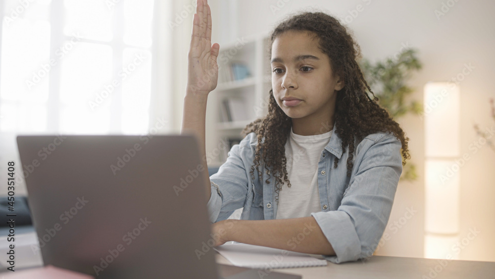 Black teen girl answering teacher while having online lesson, distance learning Black teen girl answering teacher while having online lesson, distance learning
