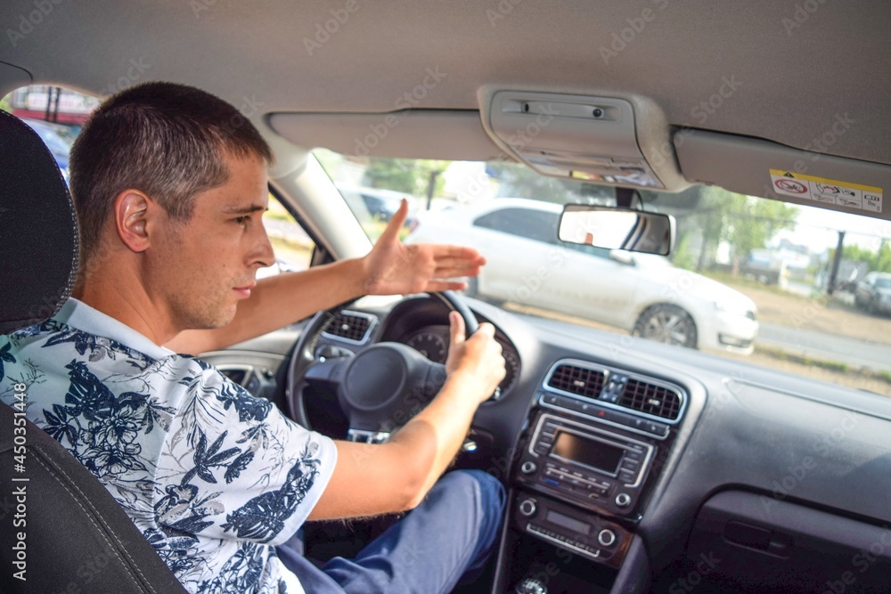 The driver on the road shows with his hand that he is giving way
The driver on the road shows with his hand that he is giving way