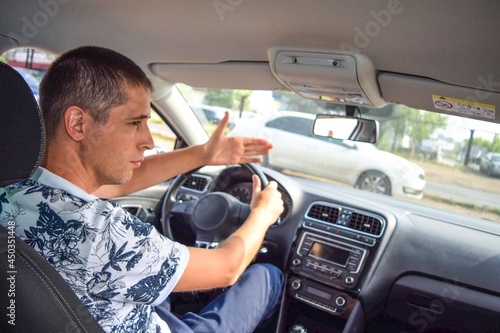 
The driver on the road shows with his hand that he is giving way
