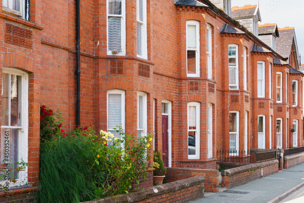 Typical red brick Victorian style terraced residential housing with bay  windows and small front gardens opening on to a street in the United  Kingdom Stock Photo | Adobe Stock