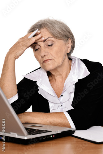 Close up portrait of elderly woman working with laptop