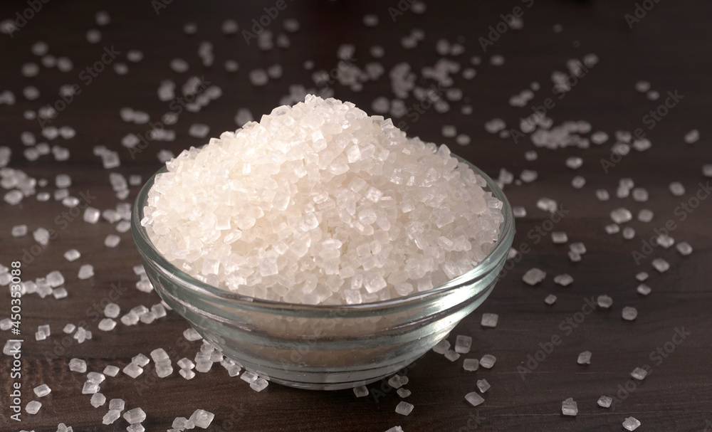 Bowl and spoon with sugar on wooden background. Bowl and spoon with sugar on wooden background.
