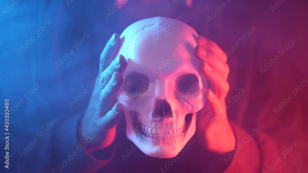 Hands Holding a Scary Skull With Some Around Hands Holding a Scary Skull With Some Around