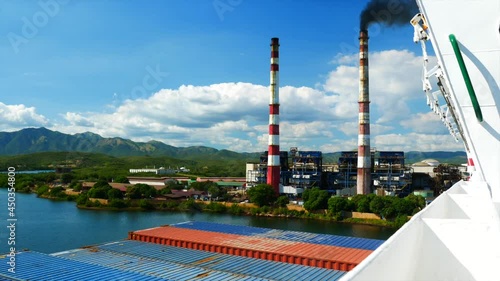 Industrial area of Santiago De Cuba with plants and pipes and smoke. 