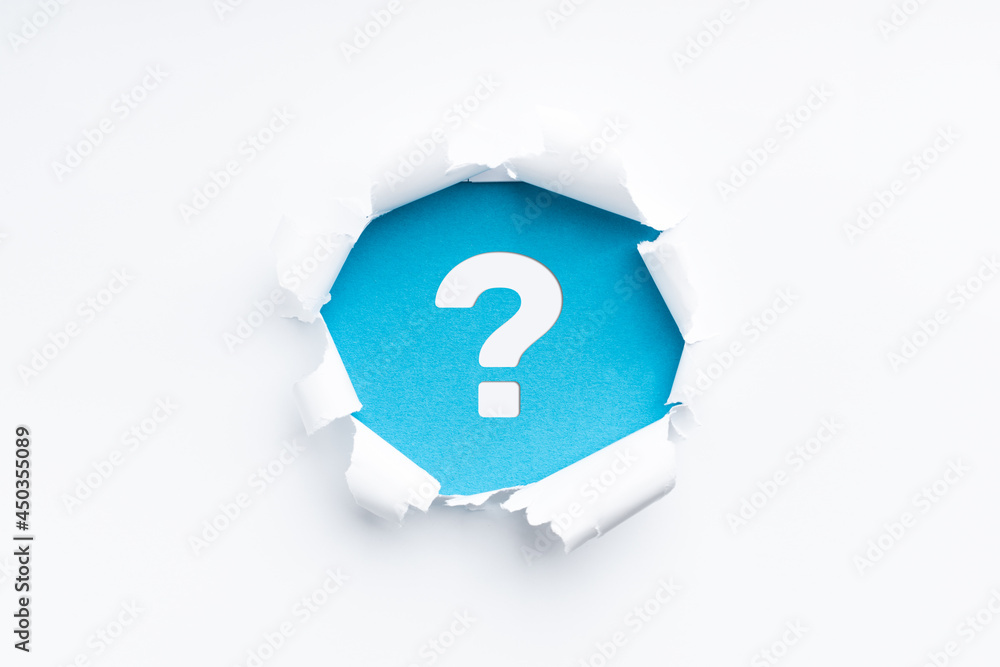torn paper revealing a questionmark symbol torn paper revealing a questionmark symbol