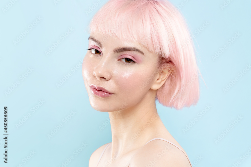Young modern blond girl with healthy glowing skin and pink hair, fresh  natural make up. Female fashion model with short stylish haircut on blue  studio background, copyspace. Stock Photo | Adobe Stock