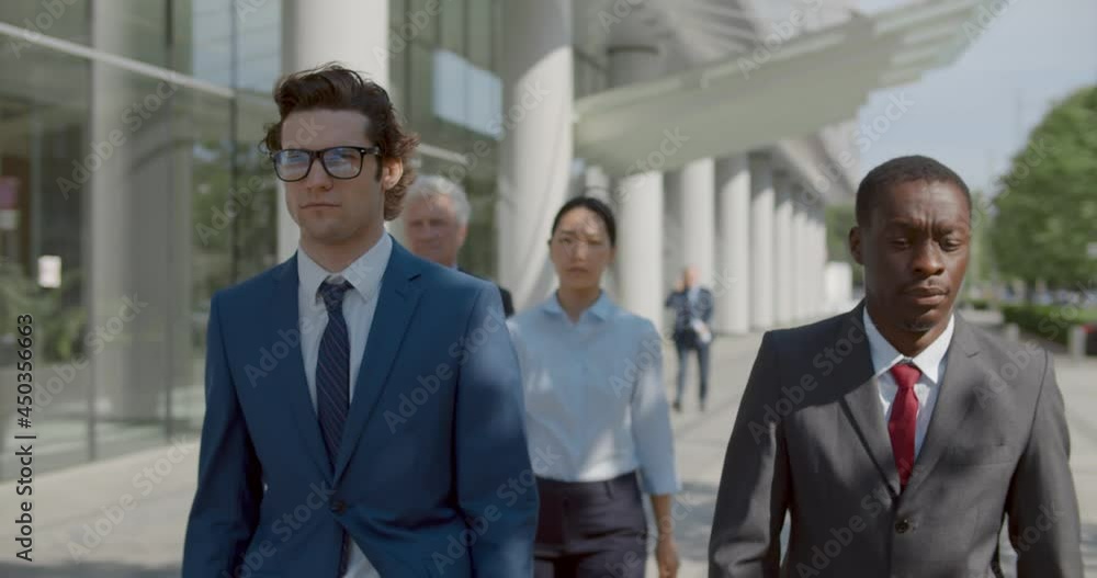 Waist up portrait of diverse business people walk outside office building Waist up portrait of diverse business people walk outside office building