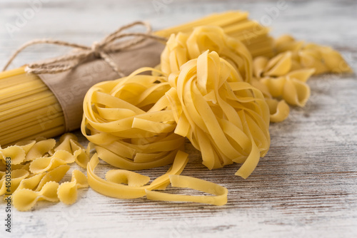Uncooked pasta on a light rustic background