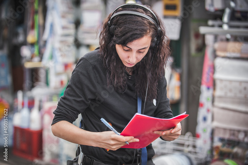 Bilde på lerret Sound director technician with headset writing sound recorder audio script