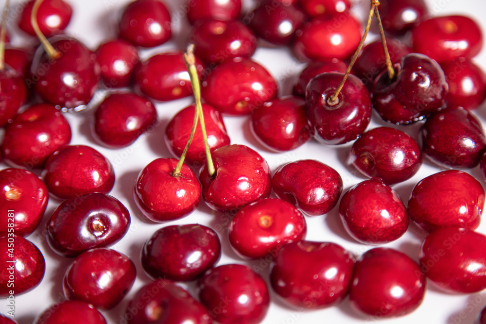 Red ripe sweet cherry lying on a tray with water. 