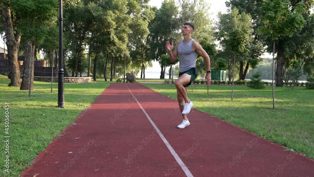 sportsman guy jogging in place with a high rise of the shin, warming up sportsman guy jogging in place with a high rise of the shin, warming up