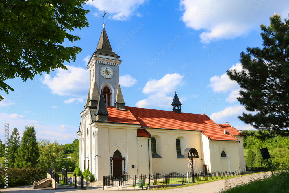 STRYSZOW ,POLAND - JUNE 01, 2021: A church with red roof in Stryszow, Poland.
