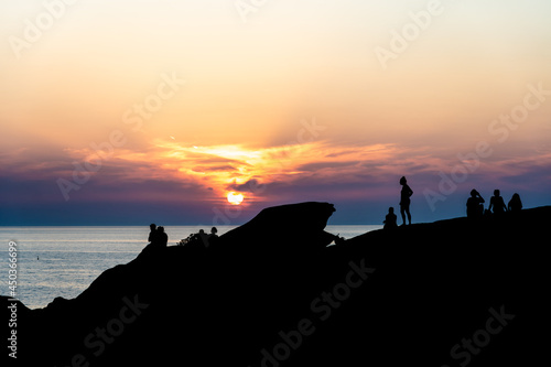 Silhouettes of people at sunset