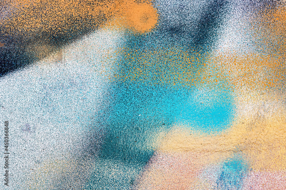 Naklejka premium A fragment of colorful graffiti painted on a wall. Abstract urban background.