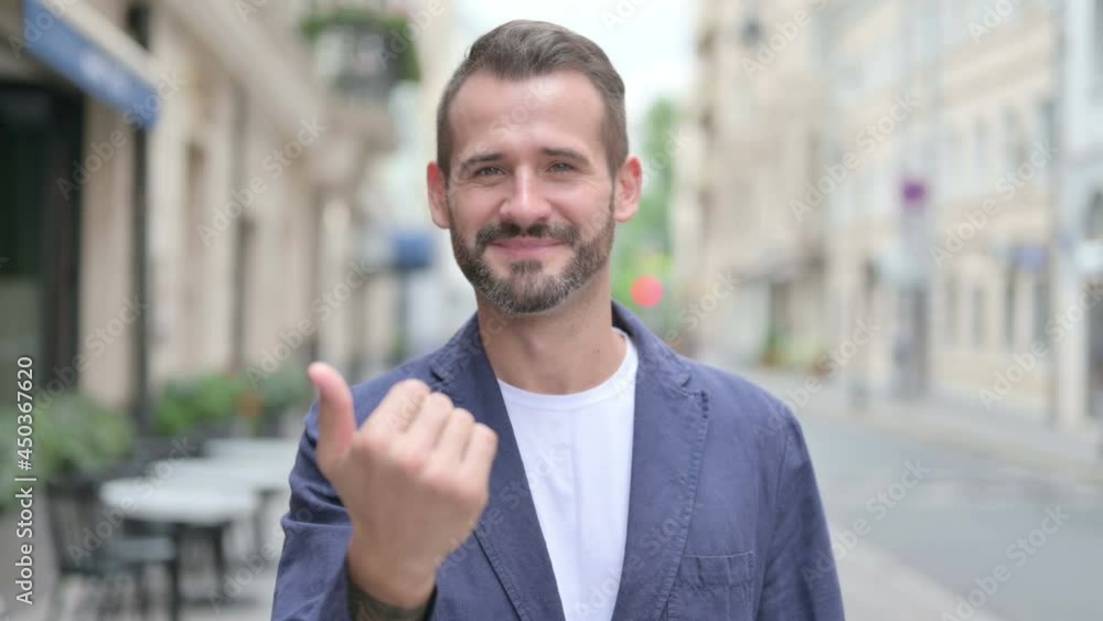 Outdoor Portrait of Man Pointing at the Camera and Inviting Outdoor Portrait of Man Pointing at the Camera and Inviting