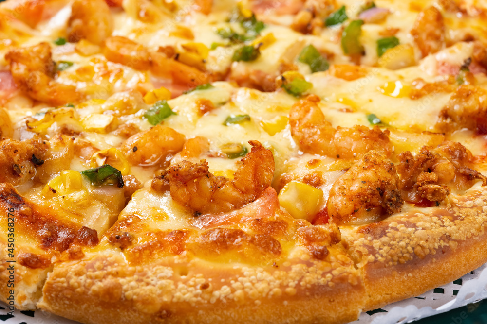 angle view fresh pizza with shrimps and bacon toppings close up angle view fresh pizza with shrimps and bacon toppings close up