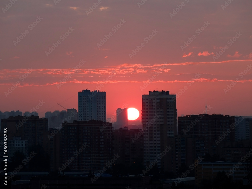 Sunrise over the city. The sun rises above the horizon