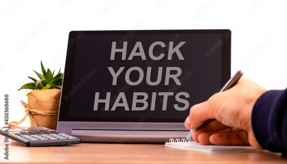 Hack your habits symbol. Tablet with words 'Hack your habits'. Businessman hand with pen, house plant. Beautiful white background. Business, psychology and hack your habits concept, copy space. Hack your habits symbol. Tablet with words 'Hack your habits'. Businessman hand with pen, house plant. Beautiful white background. Business, psychology and hack your habits concept, copy space.