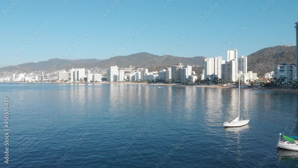 Beautiful view of the beach, aerial view of the beach, acapulco beach seen from above. Travel and vacation concept. Colorful sunset on the beach. Aerial video