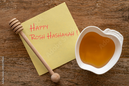 Happy Rosh Hashanah. Greeting card Rosh Hashanah Jewish holiday, fresh honey, and honey stick over wooden background. Rosh Hashanah concept.